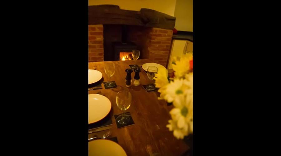 Benbow Cottage - dining infront of a roaring wood burner