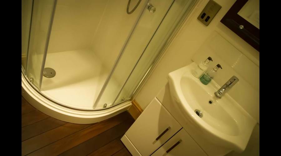 Master bedroom en suite shower room with ship wooden flooring