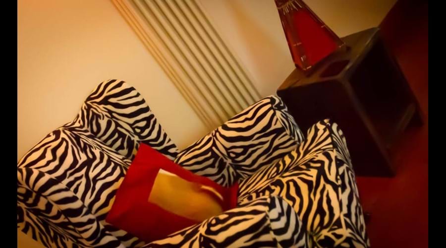 Lounge chairs with an African feel and contemporary radiators throughout