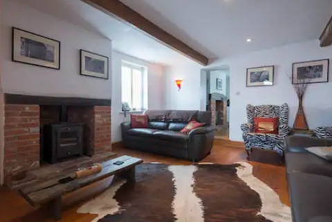Benbow Cottage lounge with wood burner