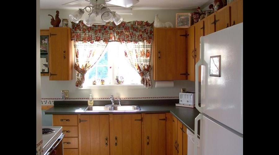 The kitchen is light and bright and located just a few steps from the dining room.
