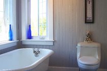 The spacious main bathroom on the upper level was completely remodeled and features a deep re-glazed bath tub