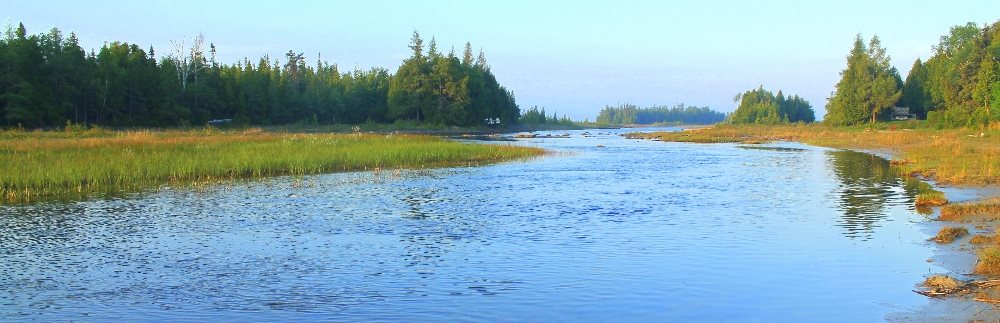The waterfront features a sandy apron leading to shallow water that is about 3 or 4 feet deep. The perfect and safe place for young children.