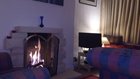 THE GAS LOG FIRE MAKES THE LIVING ROOM VERY COSY WHEN THE WEATHER OUTSIDE OUTSIDE IS UNINVITING