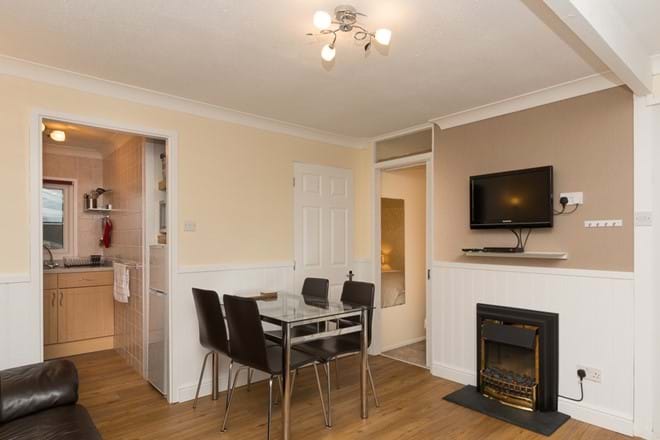 Open plan dining area with flat screen TV, DVD & feature fire
