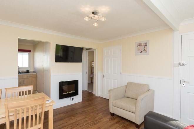 Spacious open plan sitting/dining/kitchen area with feature electric fire & digital TV