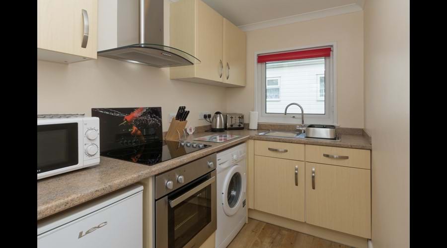 Modern fully equipped kitchen with washing machine