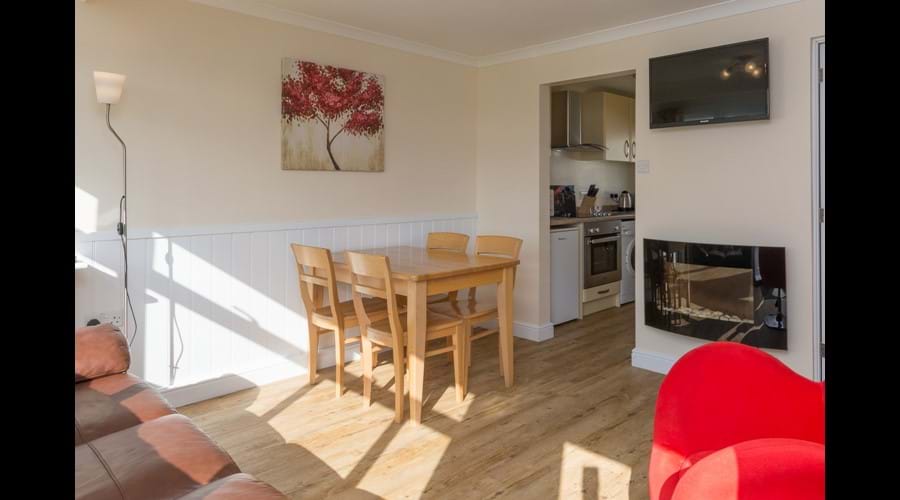 Open plan dining area with flat screen TV & feature fire