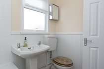 Modern bathroom with electric shower over bath