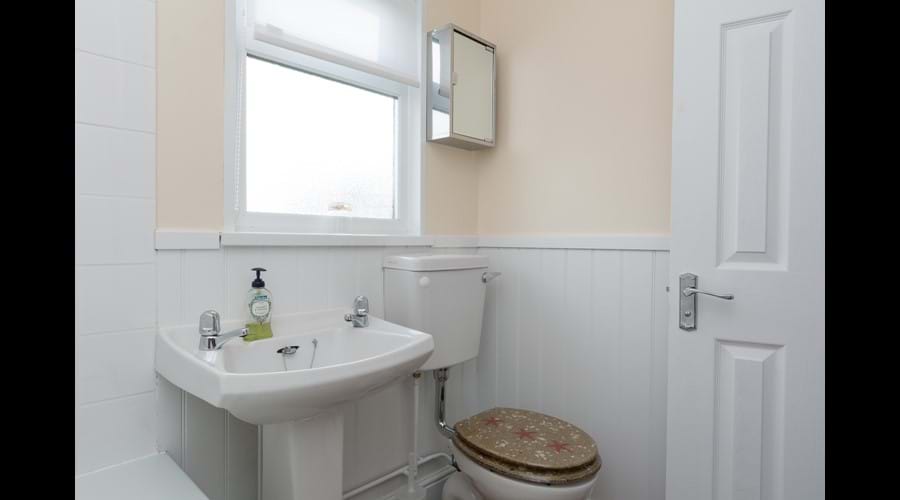 Modern bathroom with electric shower over bath
