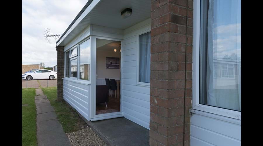Open porch with communal grassed area to front