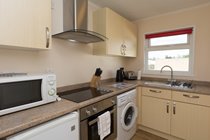 Modern fully equipped kitchen with washing machine