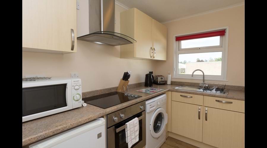 Modern fully equipped kitchen with washing machine