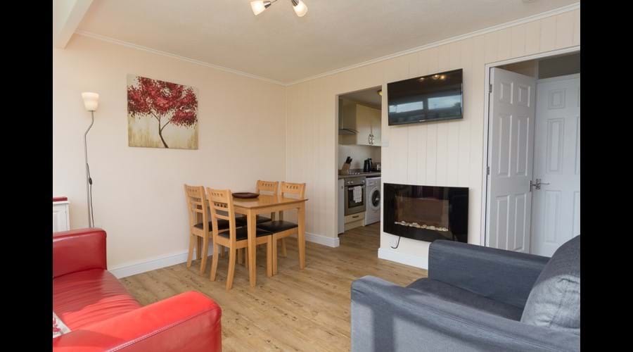 Open plan sitting/dining area with flat screen TV & feature fire