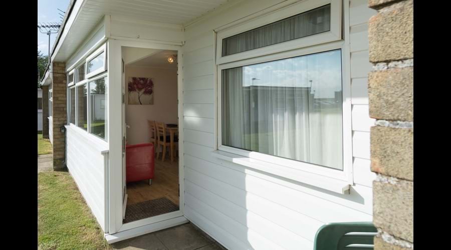 South facing open porch area and grassed area outside