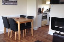 Open plan dining area with flat screen TV & feature fire