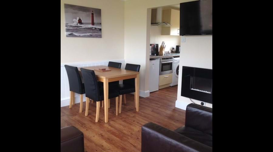 Open plan dining area with flat screen TV & feature fire
