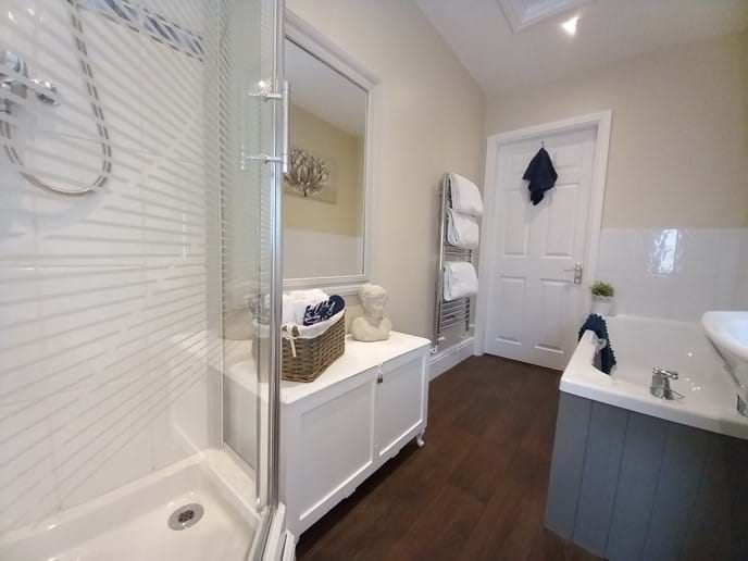 Spacious bathroom and large corner shower and separate bath