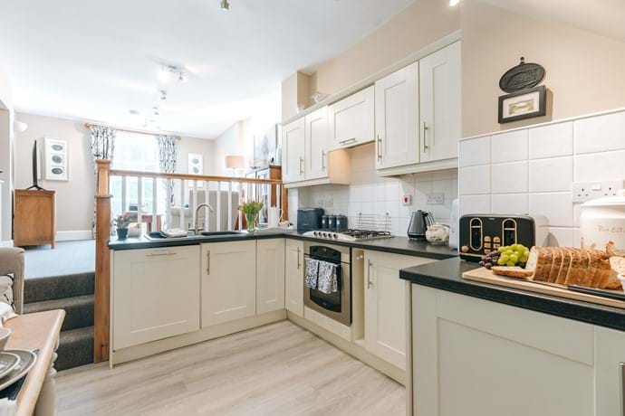 Open plan fully equipped kitchen, even a dishwasher. 3 steps up to the cosy lounge