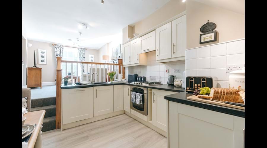 Open plan fully equipped kitchen, even a dishwasher. 3 steps up to the cosy lounge