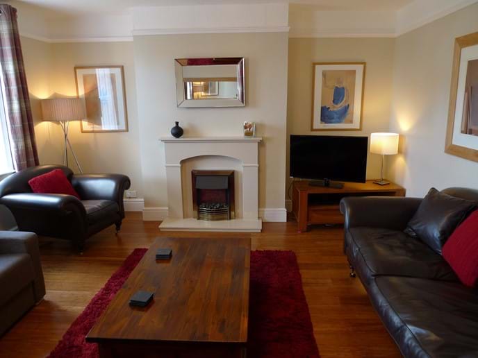 Front sitting room with leather sofa, TV, DVD, Electric fire