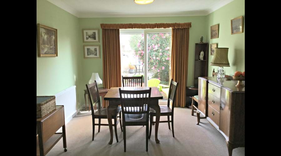 Dining area with walnut furniture over looking garden.