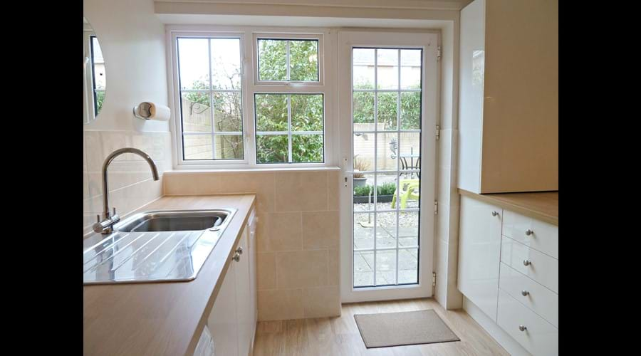 Newly fitted kitchen with direct access to rear garden.