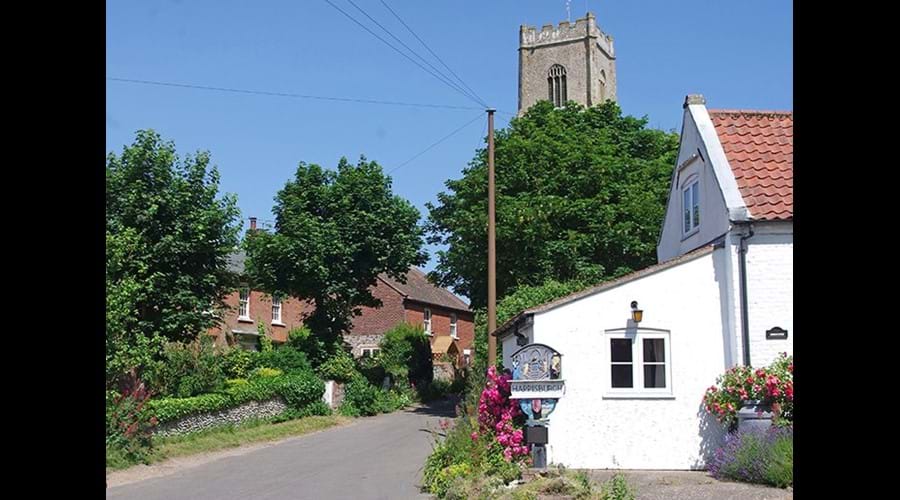 Happisburgh village sign and a glimpse of Albion cottage