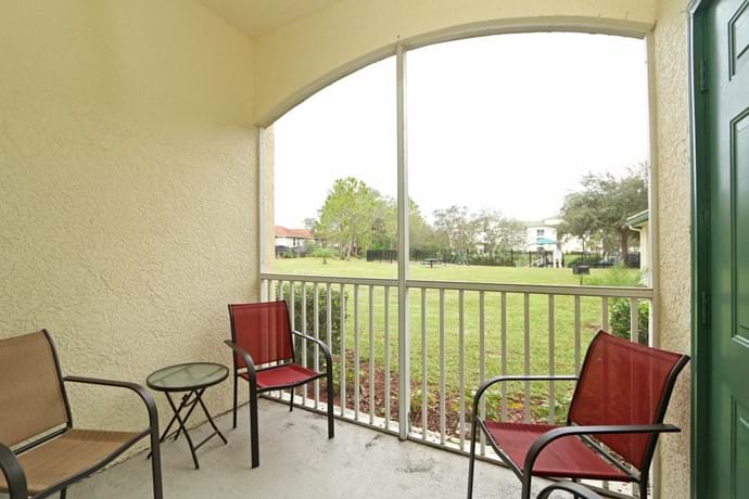 The screened balcony at 13-102  with view over lawns to the Children