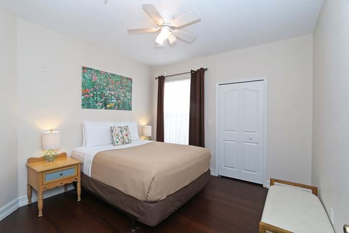 Bedroom 2  at 13-102 with walk in closet, chest of drawers, large TV, ceiling fan and air con
