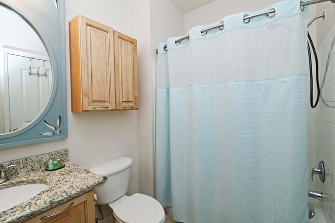 Bathroom 2 at 13-102.  Shower over bathtub, toilet and washbasin.  Granite top