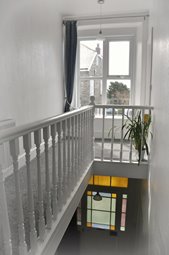 Landing area with sunny window seat