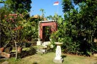 Porch entrance to pool and terrace. Roof of garden cottage visible in the background.