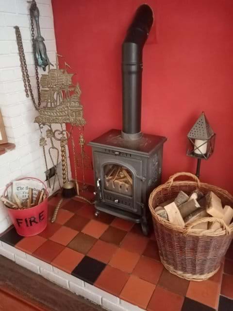 A large basket of logs is provided.