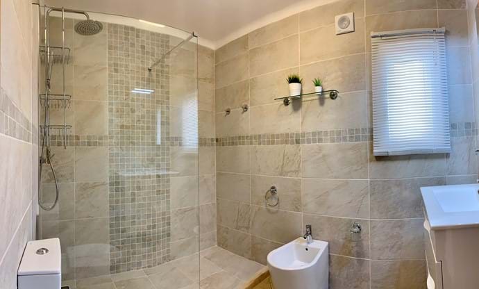 Main bathroom with walk in shower and modern suite, mirror over sink