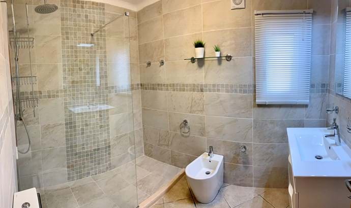 Main bathroom with walk in shower and modern suite