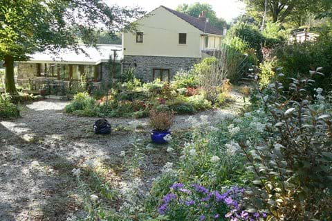 Main house in the middle with Bach cottage on the left and The Cottage up on the right