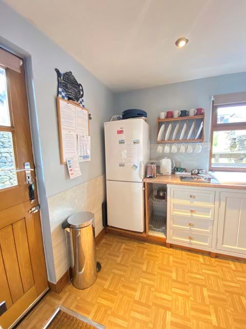 Stable door in kitchen, full sized fridge freezer. Dishwasher, washing machine and tumble dryer out of view