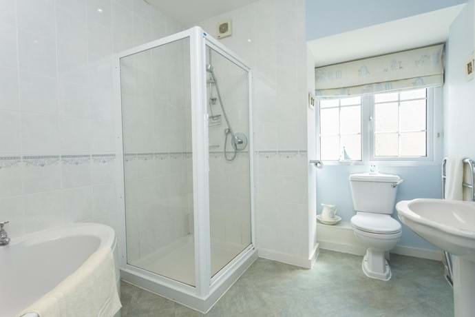 Large bathroom with corner bath and separate shower