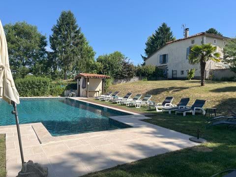 The large swimming pool with the main house in the background