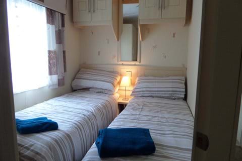 Two single beds in the second bedroom