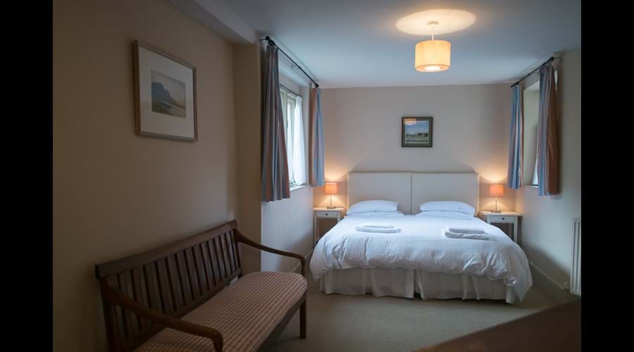 Larger ground floor bedroom made up as a Super king sized bed.