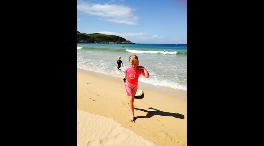 Body boarding fun with kids in August on Kiloran
