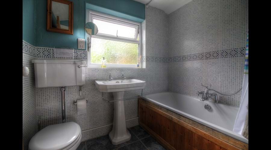 Family bathroom with double ended bath and over bath shower