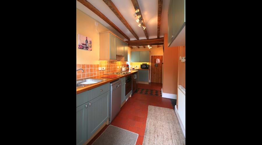 Modern fully equipped kitchen with hob, oven, dishwasher, fridge, freezer, microwave and even a pantry