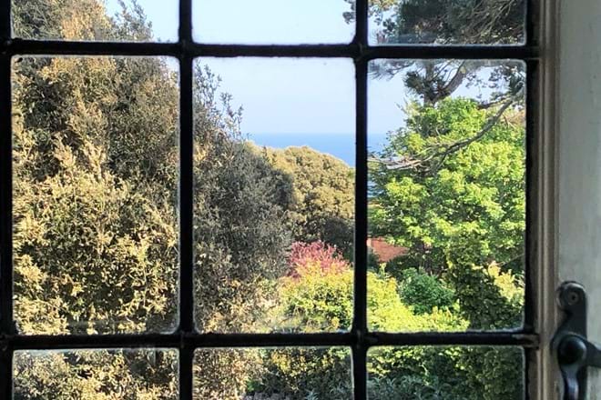 Room 1 – the view across the garden to Durlston Bay 