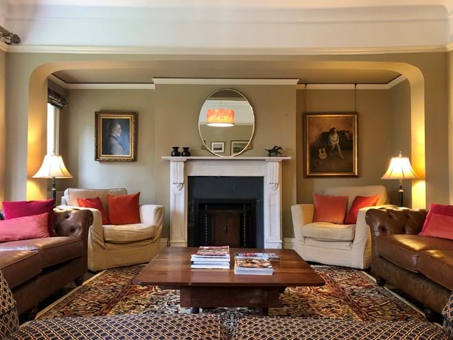 The lounge – this sunny room has garden views and an open fire