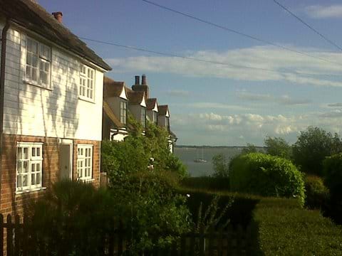 Mersea Island Cottage by the coast with boat on the water in view