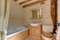 Family bathroom with over-bath power shower and magic heated mirror whose lights turn on at the wave of a hand...