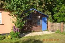 Playhouse in the garden…lawnmower and ironing board inside